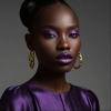 Image is a high-fashion portrait photograph featuring a person with dark skin and striking facial features